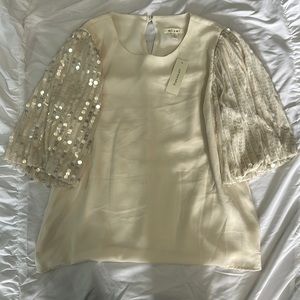 Dressy cream color top with sequin sleeves, size s